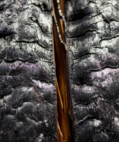 Close-up of soot and smoke damage on a wooden wall before restoration.