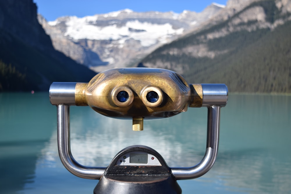 gray and black binoculars on top of snow covered mountain during daytime