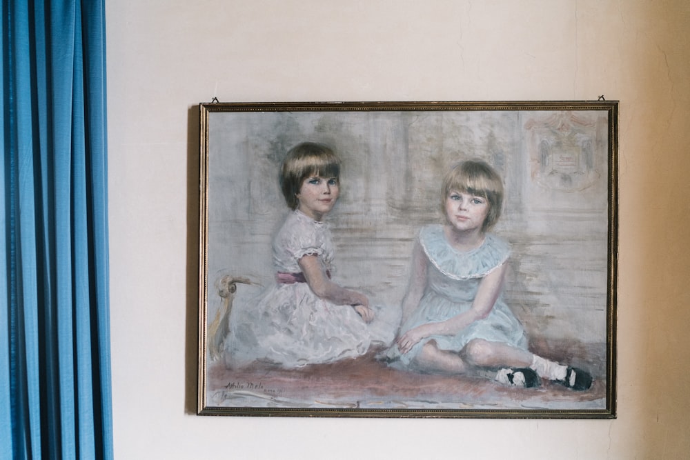 2 girls sitting on floor painting