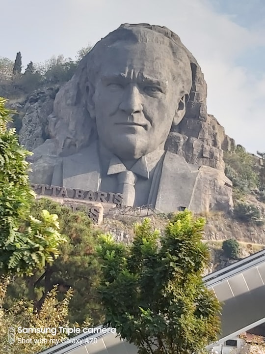 gray concrete statue near green trees during daytime in İzmir Turkey