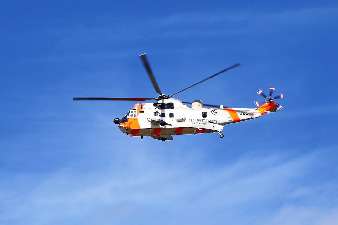 orange and white helicopter flying under blue sky during daytime, SAR helicopter in polar Norway close to North Cape.<p></figure>Very often the conditions are much harder than on this day - and on every day we shall thank these women and men risking their life to help and protect others. All the best for you!