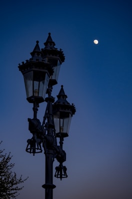 black metal cross with moon in the sky