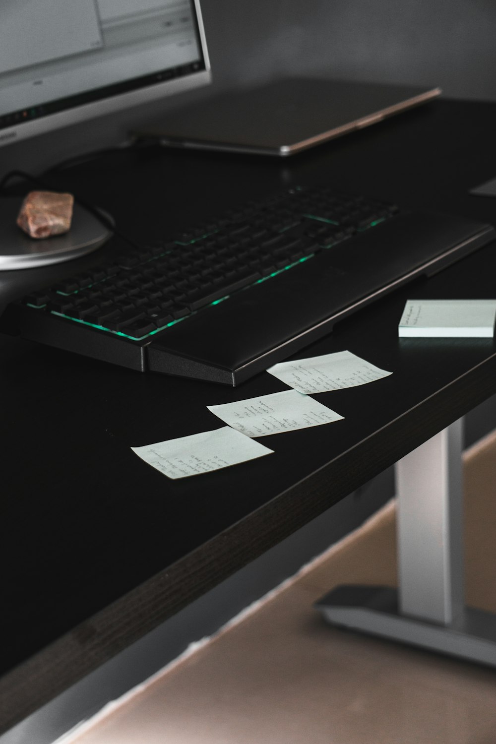 black laptop computer on brown wooden table