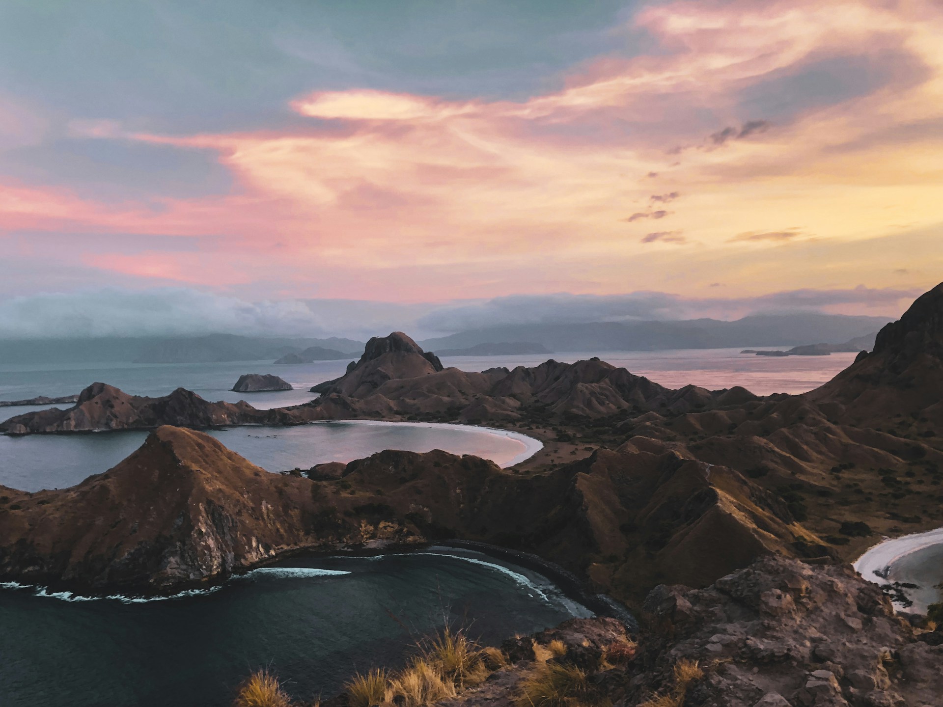 body of water between mountains during sunset