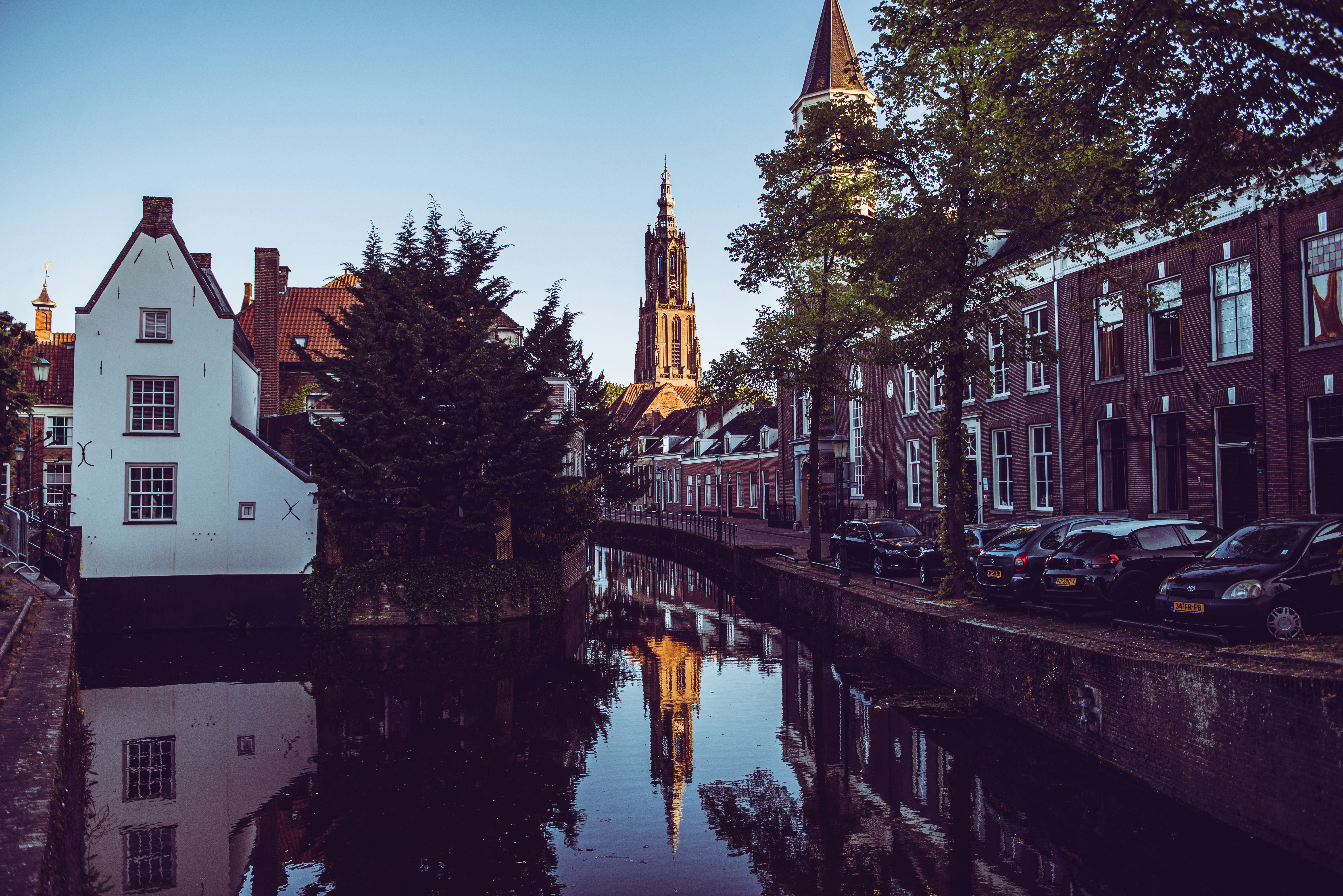 white boat on river near brown concrete building during daytime