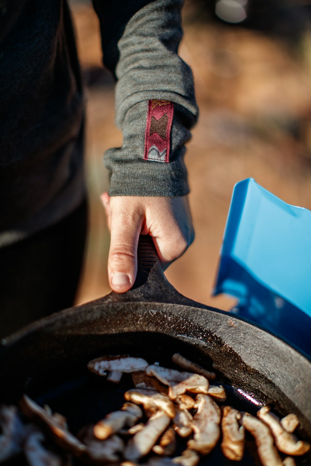 person holding black round plate