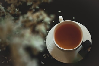white ceramic mug with brown liquid