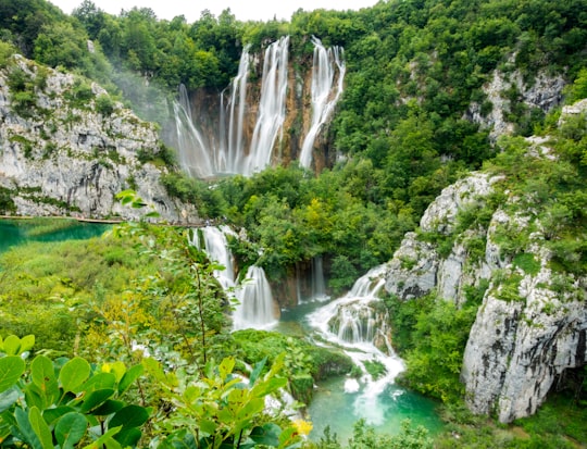 waterfalls in the middle of green trees in Plitvice Lakes National Park Croatia