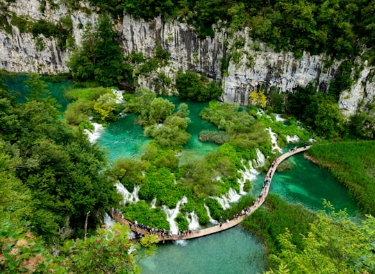 aerial view of river between rocky mountains during daytime in Plitvice Lakes National Park Croatia