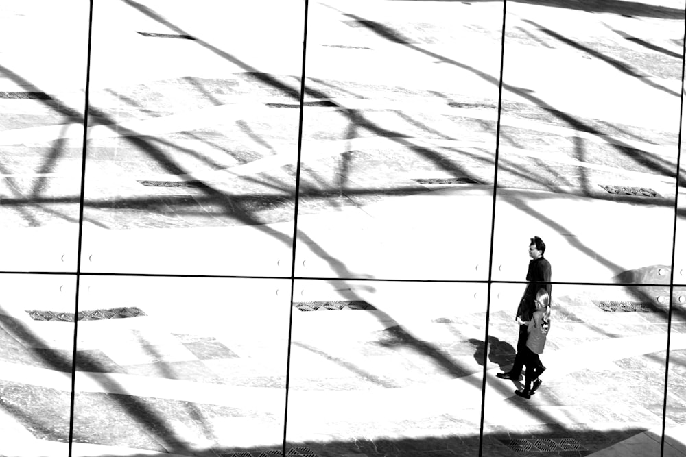 silhouette of person walking on white sand during daytime