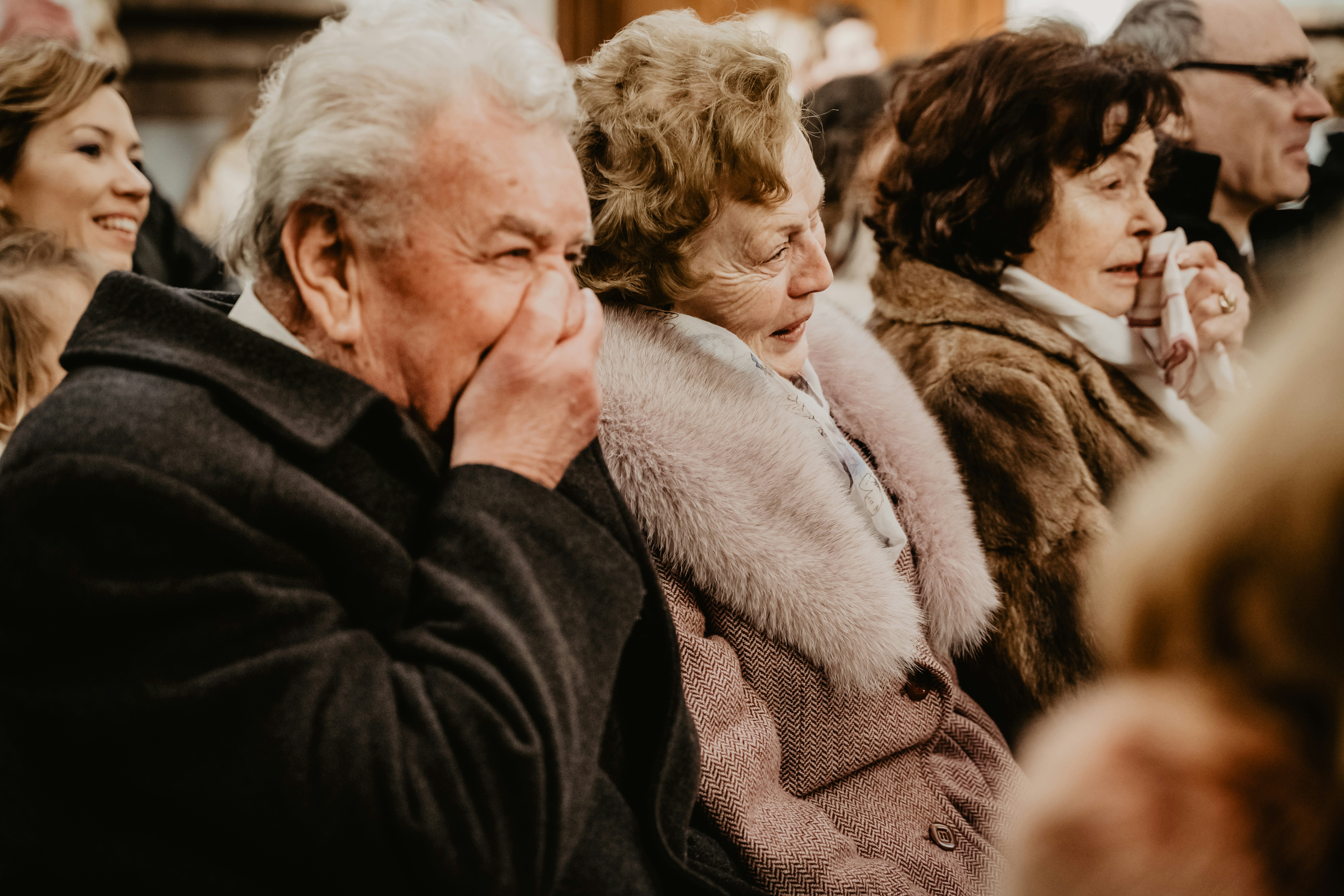 白い毛皮のコートの女性にキスする黒いコートの男