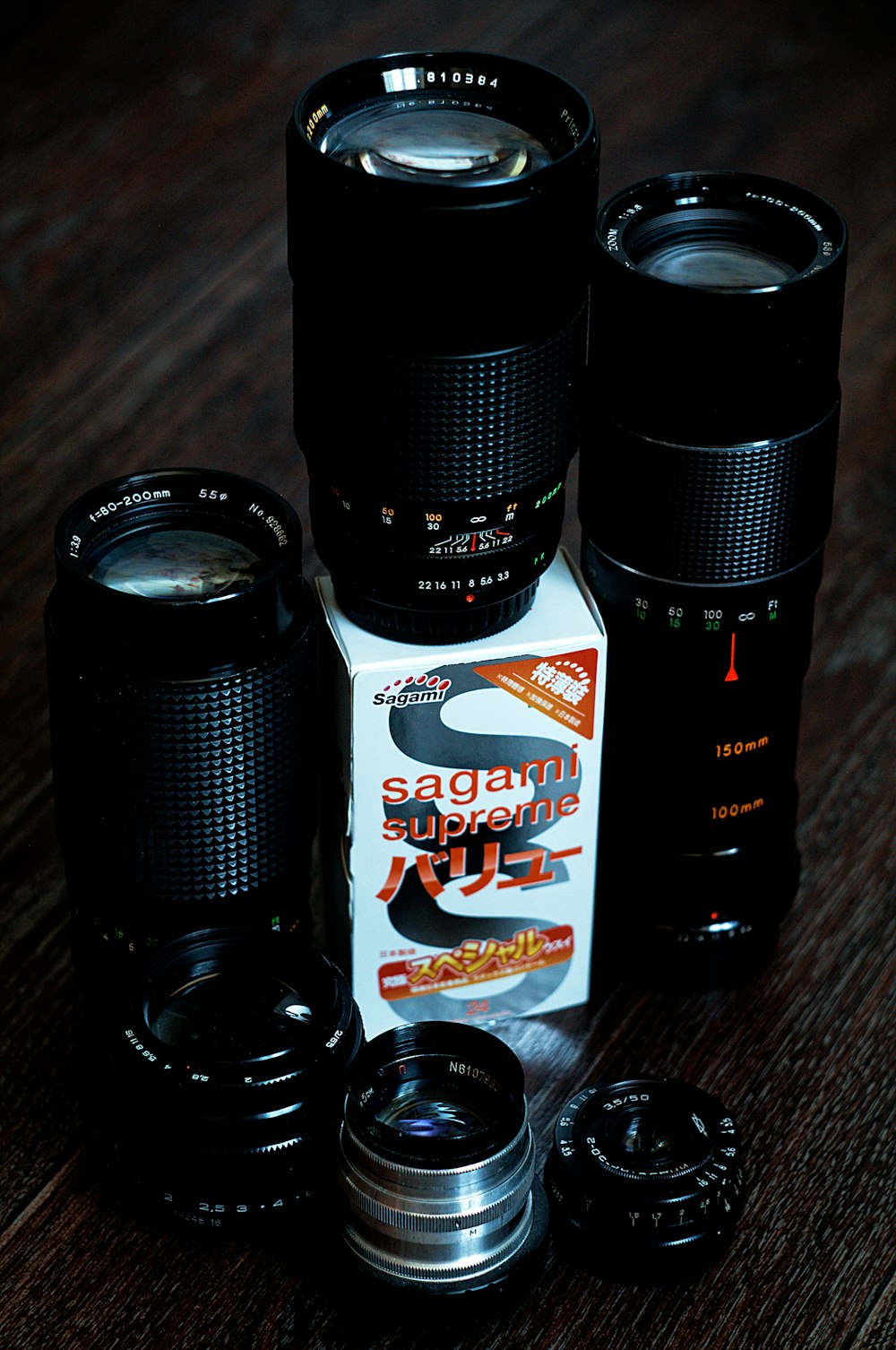 a couple of cameras sitting on top of a wooden table