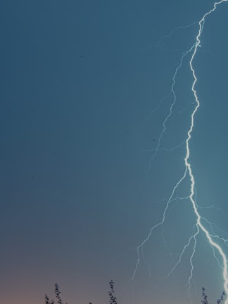 Lightning bolt graphic overlay on a high-contrast action shot of a fierce rally in progress.