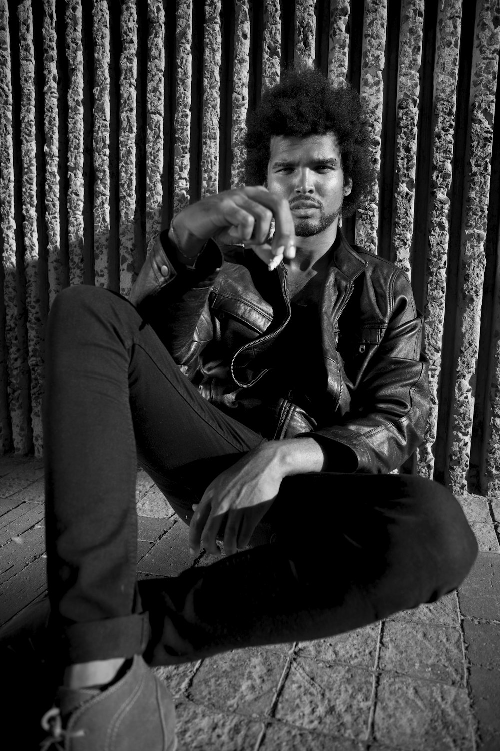 man in black coat sitting on the floor