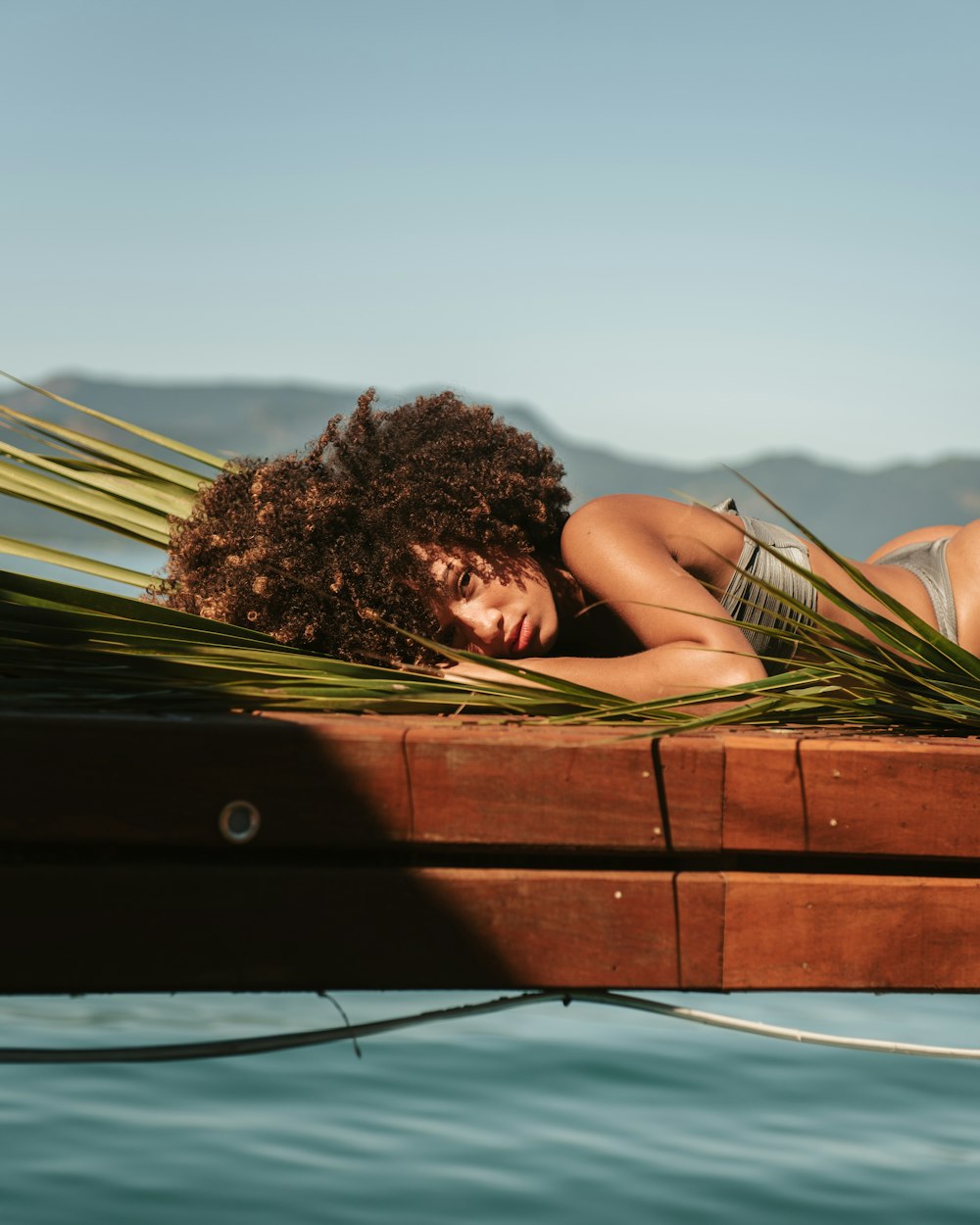 woman lying on brown wooden board