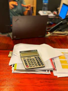 silver and black calculator on white printer paper