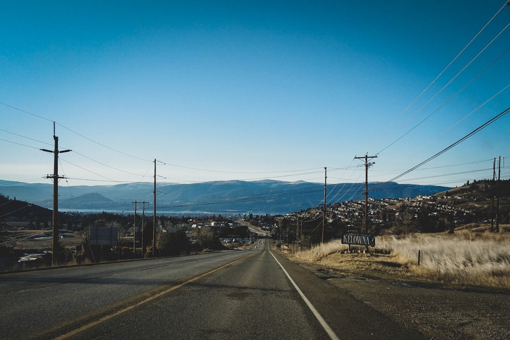 black asphalt road under blue sky during daytime