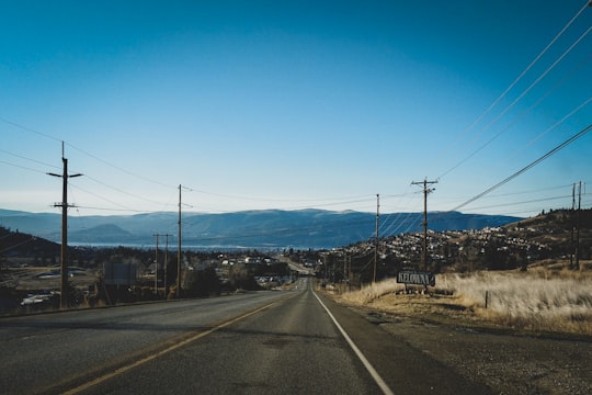 black asphalt road under blue sky during daytime in Kelowna Canada