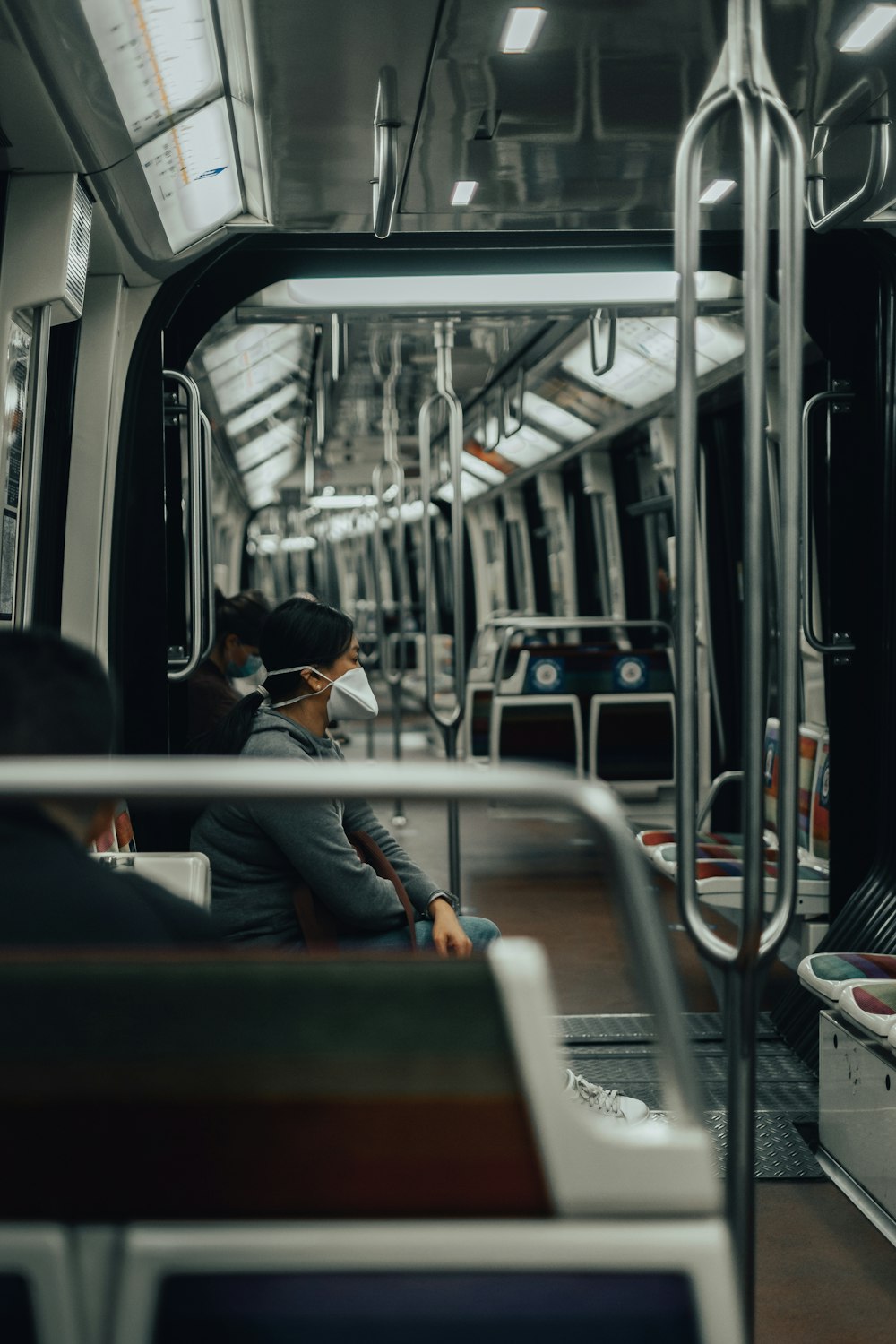 man in black jacket standing in train