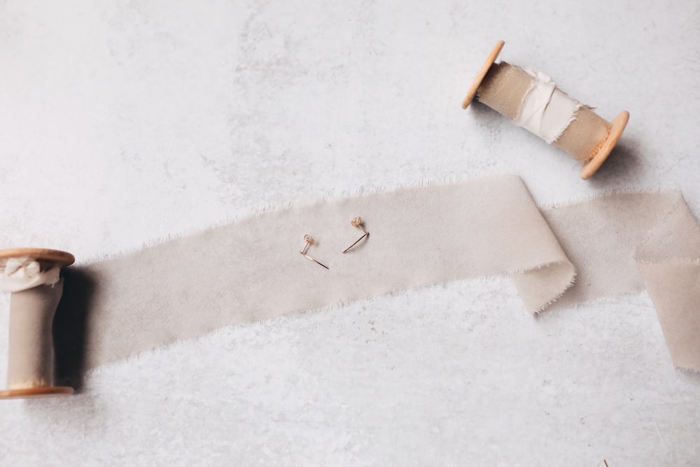 white and brown wooden stick on white textile