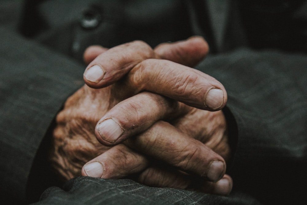 persons hand on black textile