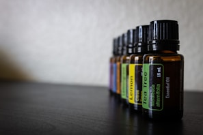 Elegant glass bottles filled with natural essential oils on a wooden table