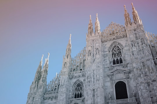 gray concrete building under blue sky during daytime in Milan Cathedral Italy