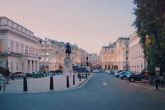 cars parked on side of the road near buildings during daytime in Piccadilly Circus United Kingdom