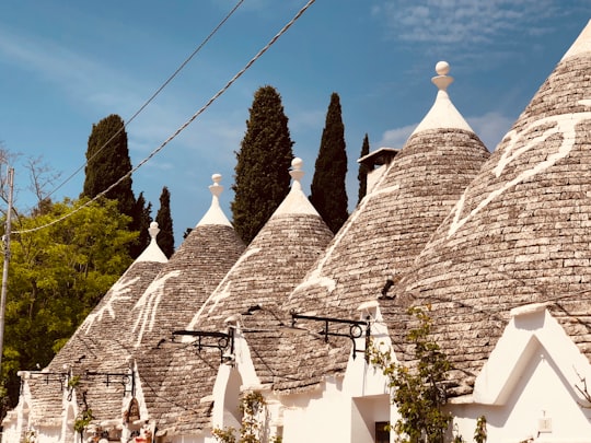 white and brown concrete house in Alberobello Italy