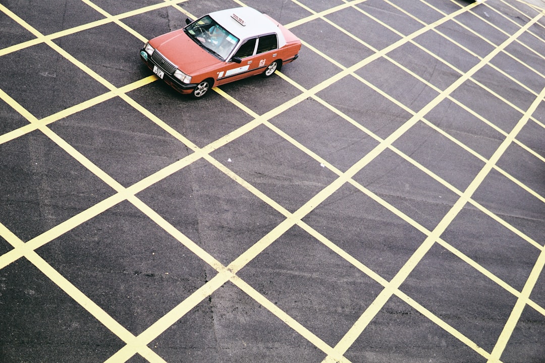 orange car on white and black road