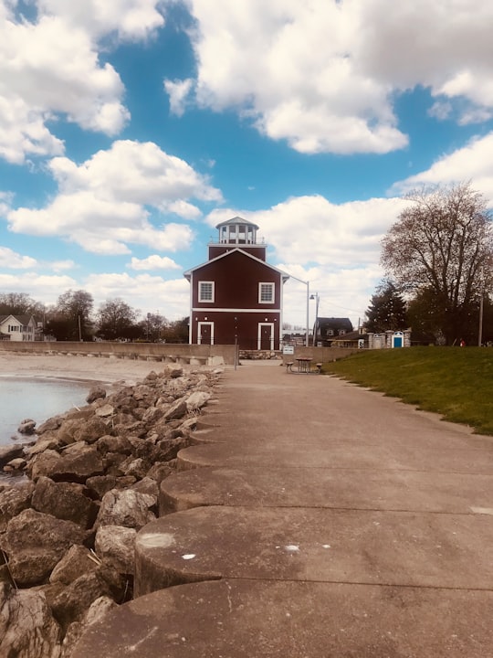 brown and white building near body of water under blue sky during daytime in Michigan United States