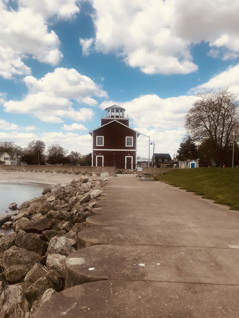 brown and white building near body of water under blue sky during daytime