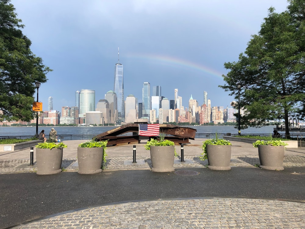 brown wooden bench near water fountain