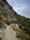 Couple hiking a scenic mountain trail with vibrant autumn colors