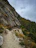 Couple hiking a scenic mountain trail with vibrant autumn colors