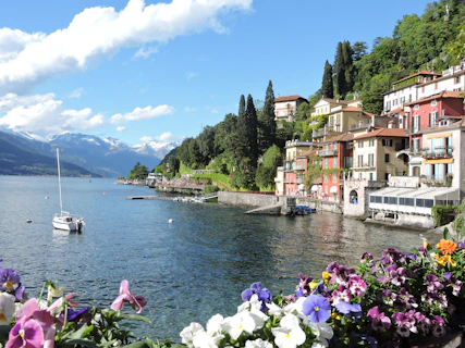 white and brown concrete houses near body of water during daytime
