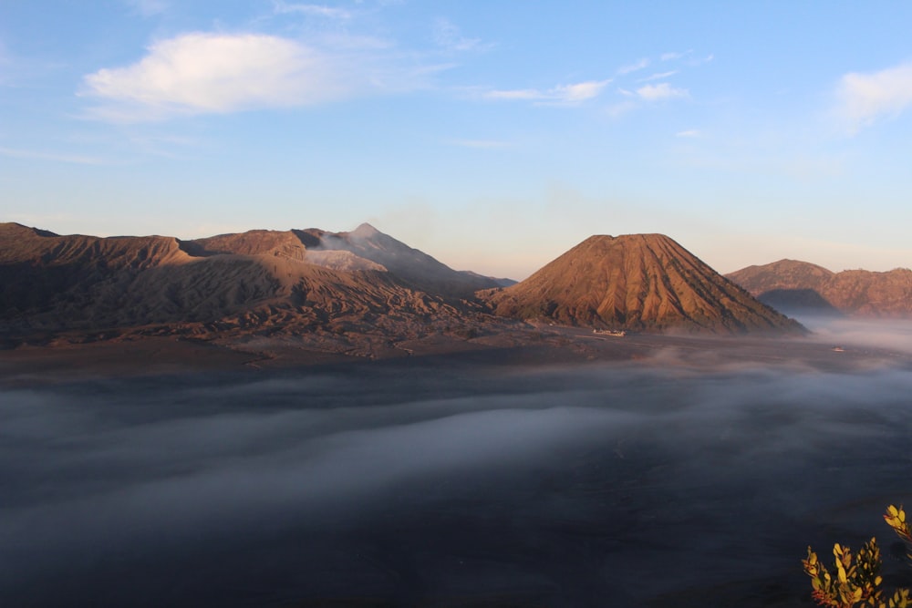 brown mountain under white clouds during daytime