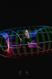 Character editing a vibrant glowing video hologram with neon accents.