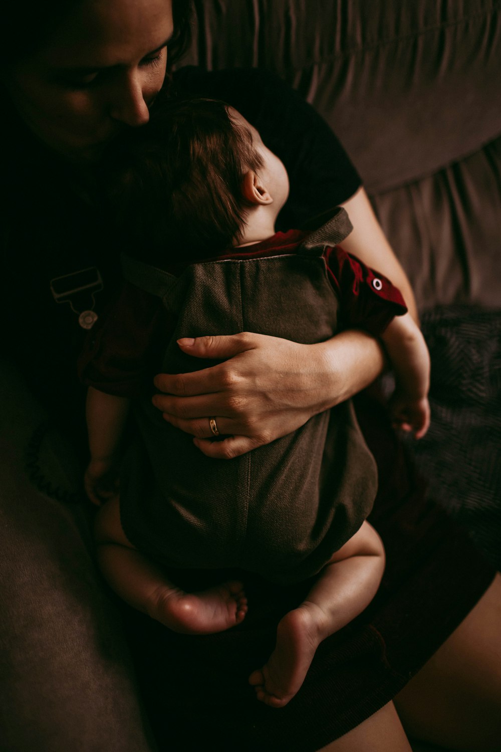 grayscale photo of baby hugging person