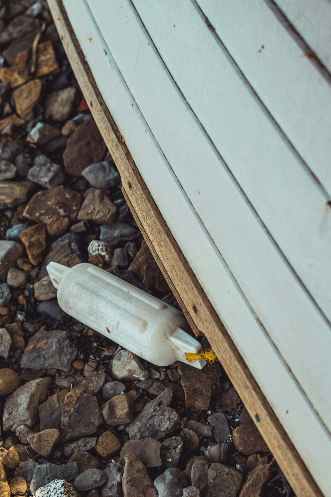 clear glass bottle on gray and brown stones