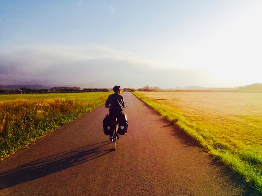 man in black jacket riding bicycle on road during daytime in Asturias Spain