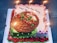 A beautifully decorated birthday cake with colorful frosting and candles on top.