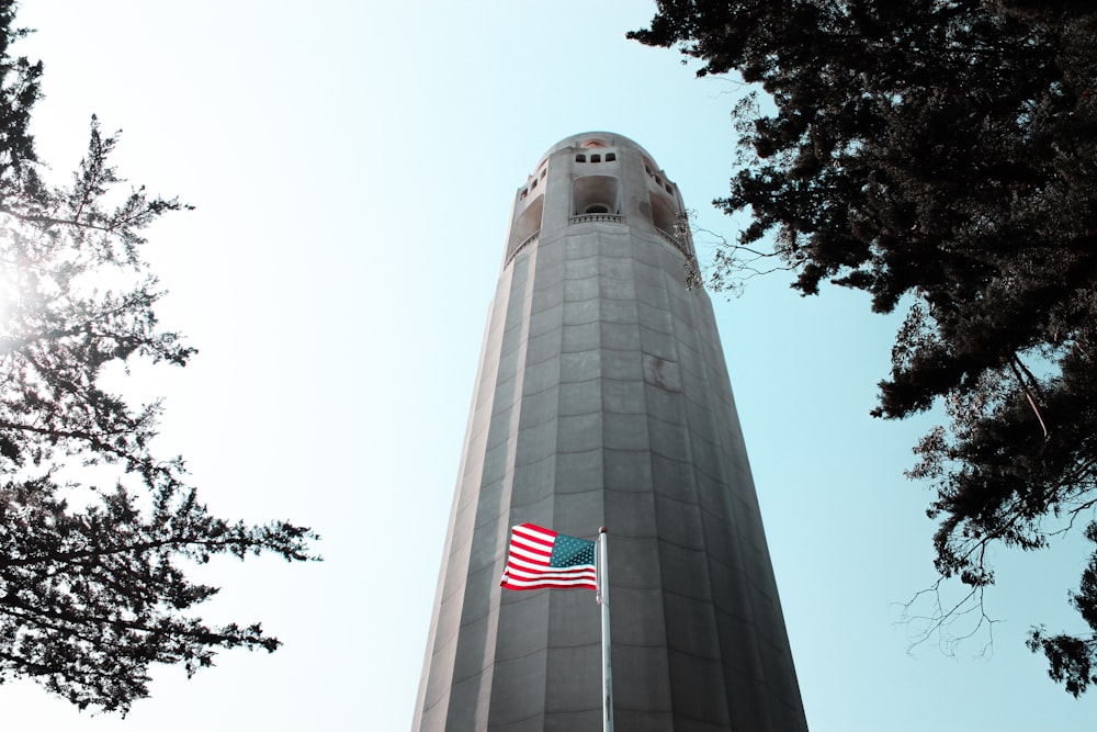 low angle photography of gray and red tower