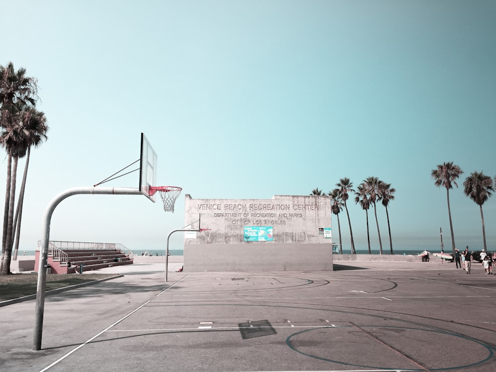 white and red basketball hoop near brown concrete building during daytime