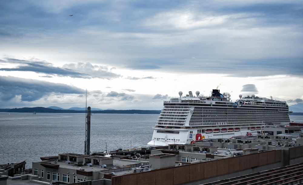 white and black cruise ship on sea under blue sky during daytime