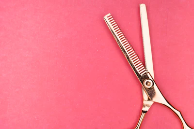 silver scissors on red textile