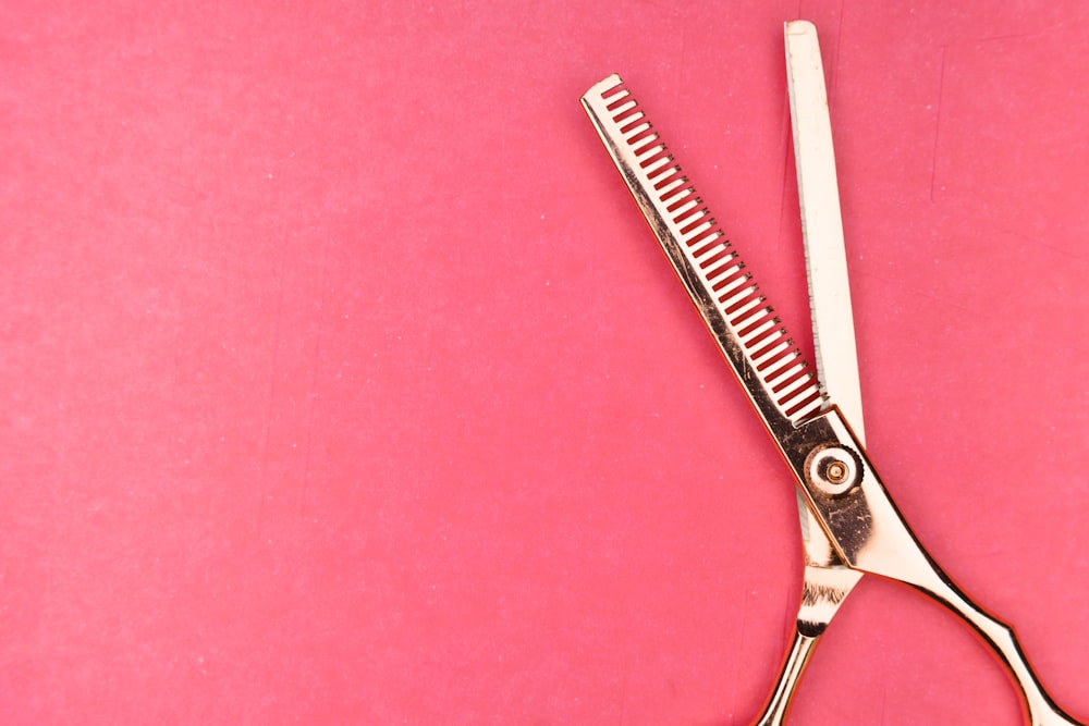 silver scissors on pink textile