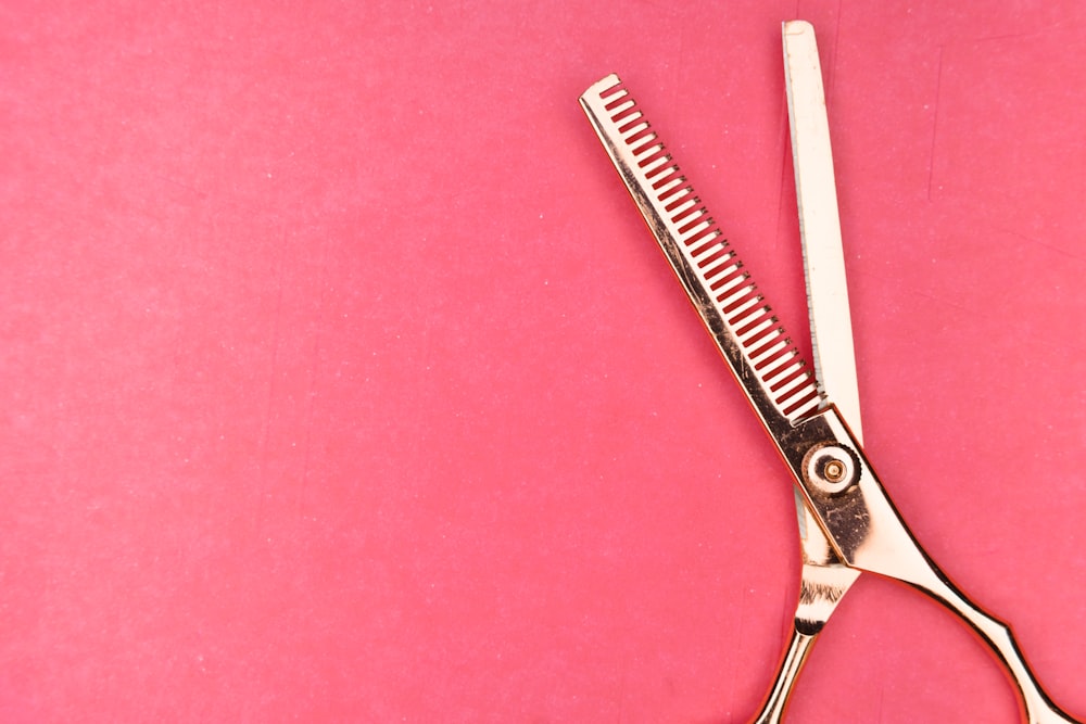 silver scissors on red textile