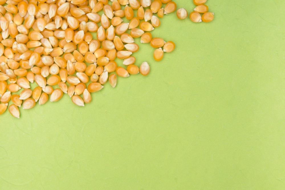 white and brown beans on green surface