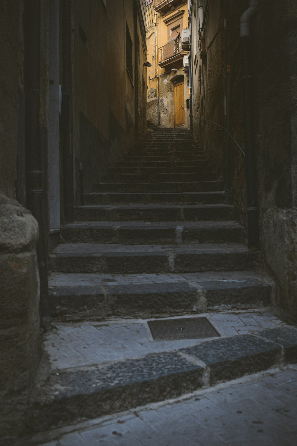 Pasillo de hormigón gris con puerta de madera marrón